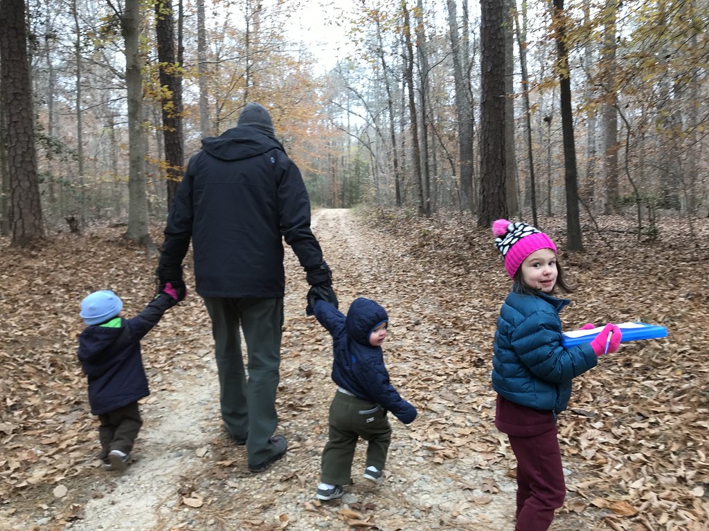 Dad and children strolling outdoors together