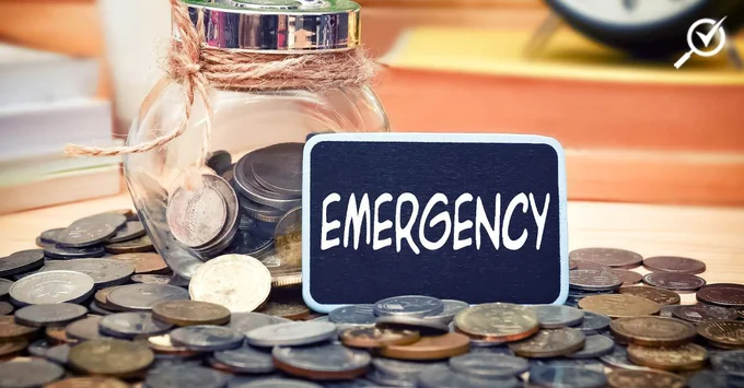 Emergency fund represented by coins and cash in a bottle