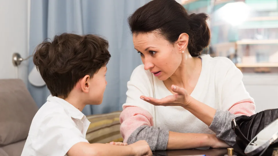 Parent comforting child while discussing real-world issues.