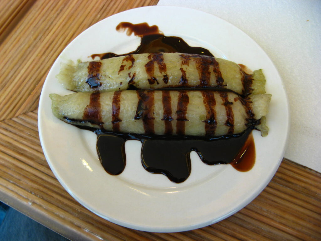 Suman with latik in a plate