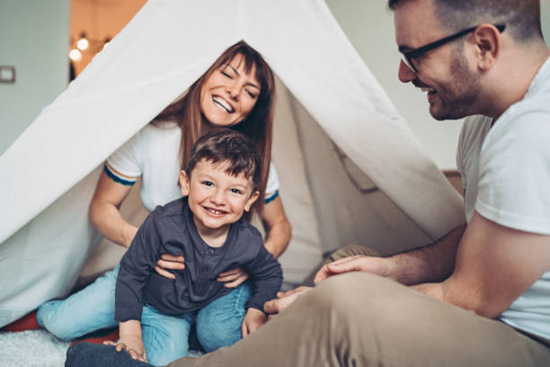 Parents and kids having a fun indoor camping experience