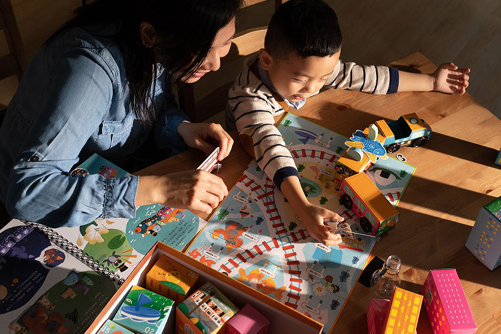 Family learning and playing with a toy train together