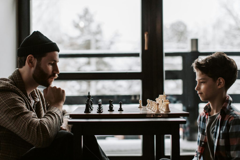 Father and son enjoying a game of chess.