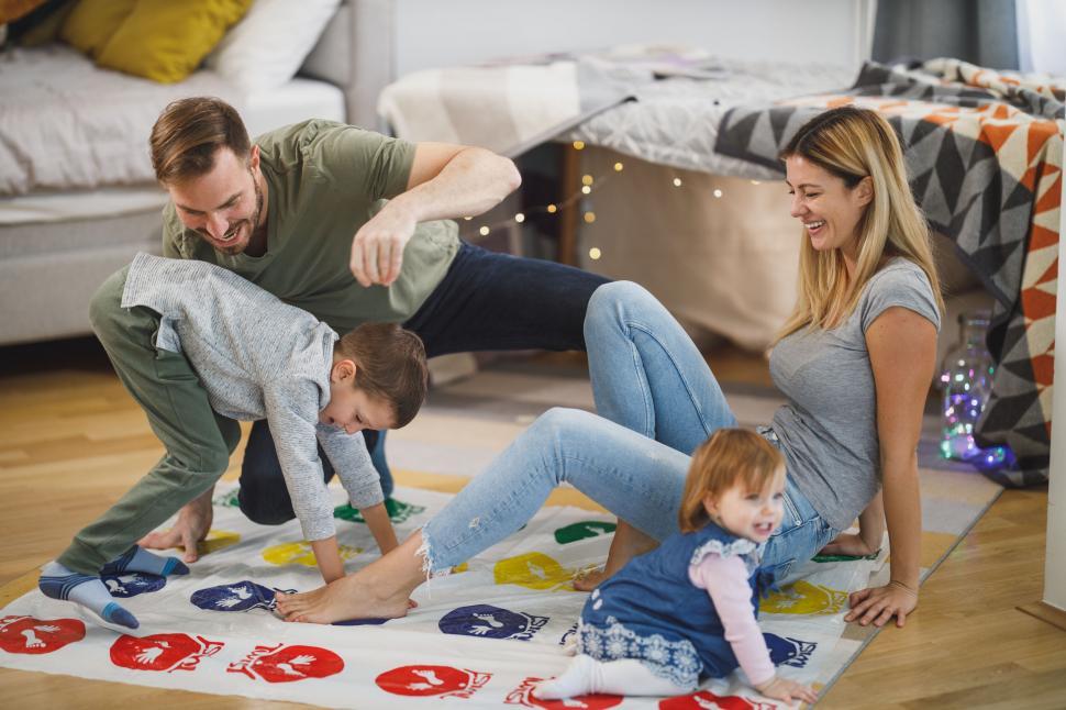 Parents and children having fun during game night.