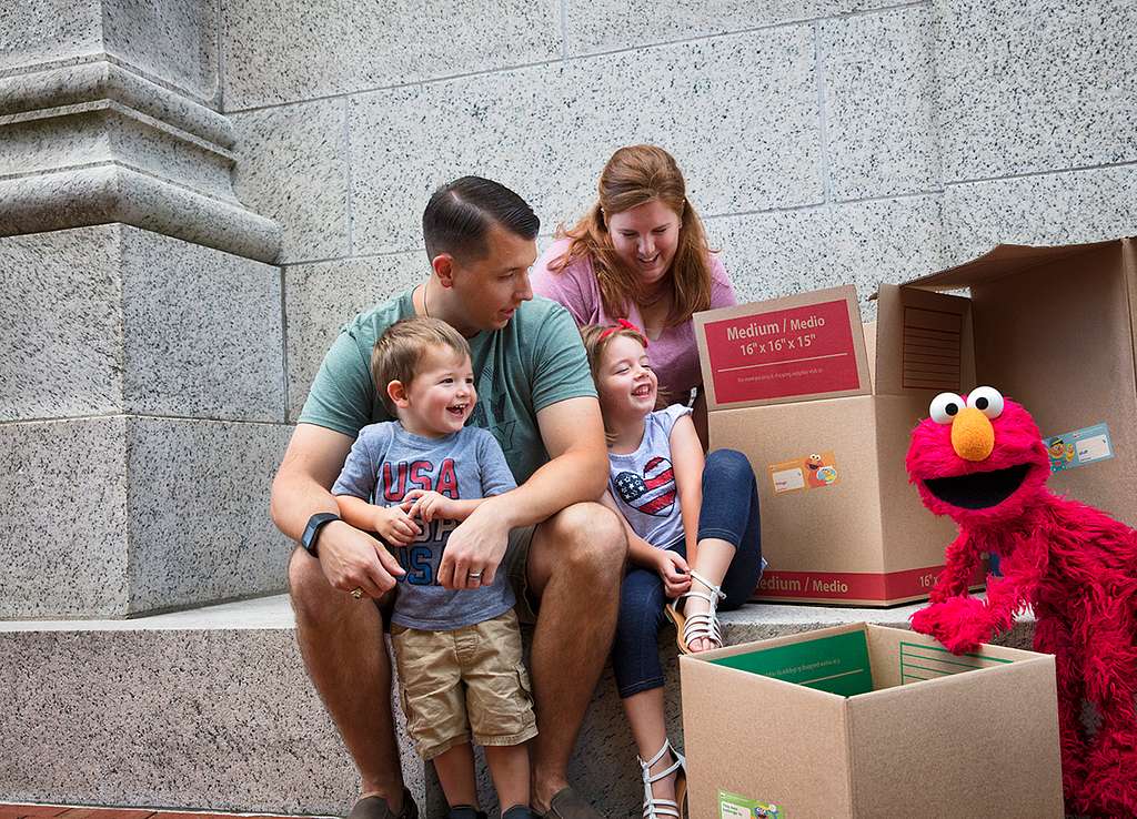 Parents and kids giving toys to charity.