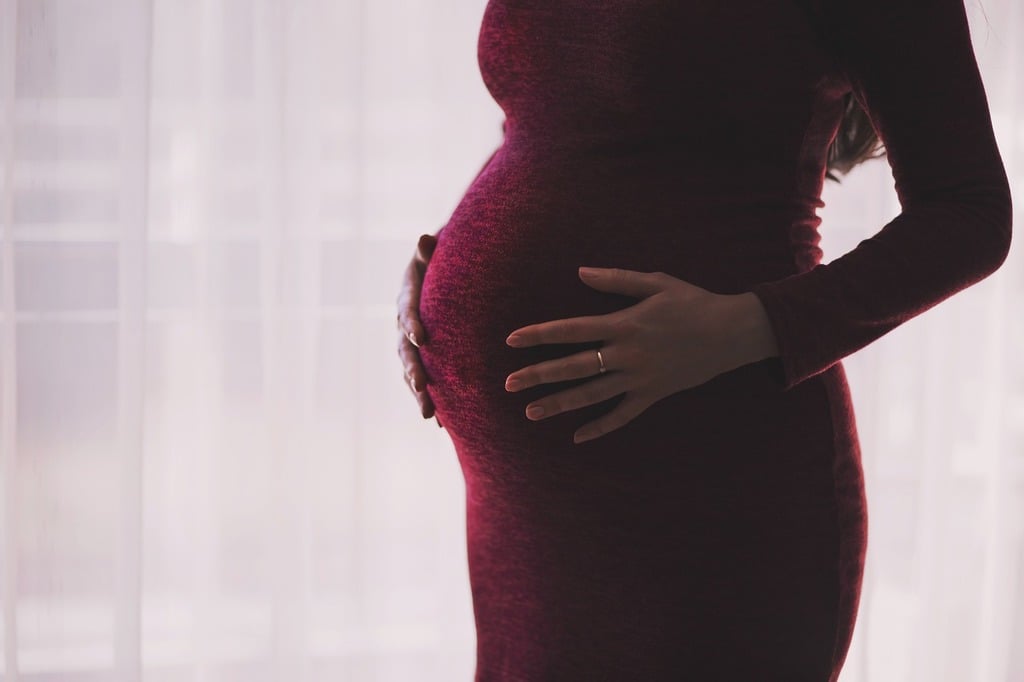 A pregnant woman in a red dress